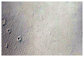 Tharsis Tholus Stratigraphy Exposed in an Impact Crater