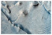 Becquerel Crater Deposits with Layered Hydrated Minerals