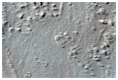 Pits and Flows near Ulysses Fossae