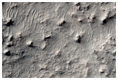 Layered Sedimentary Rocks on Floor of Old Crater