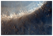 Crater with Chutes Cutting Wall-Mantling Material