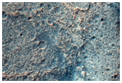 Stepped Mesas and Pits on Crater Floor with Olivine-Rich Bedrock