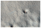 Northern Plains Landforms and Ejecta From Youthful Crater
