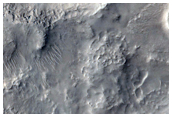 Layered Material within Small Crater in Nilosyrtis Mensae