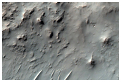 Double Impact with Possible Mafic and Phyllosilicate Signatures