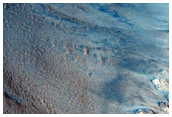 Light-Toned Layered Rock Outcrop in Wall of a Crater in Acidalia Region
