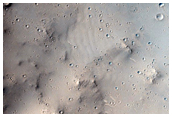 Isolated Tail of Dark Material Beyond a Crater