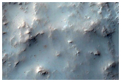 Small Crater on Floor of Huygens Crater with Possible Phyllosilicates