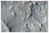 Linear and Curvilinear Ridges Emerging From Eroded Terrain