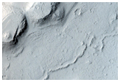 Layered Rocks and Scarp on Crater Floor
