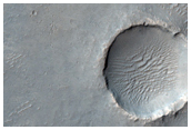 Possible Light-Toned Layering along Plains Southwest of Melas Chasma