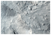 Sinuous Ridges with Scroll Bars at a Scarp