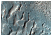 Crater Floor Material and Rounded Mesas