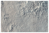 Layered Deposit in Craters along Reull Vallis