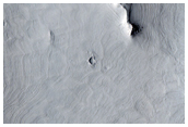 Layering Under Crater Ejecta in Janssen Crater
