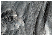 Material Flowing Through Gap in Crater Rim East of Hellas Planitia