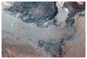 Mantle Material and Adjacent Low Albedo Surfaces