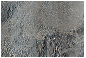Layered Materials among Bedforms Southwest of Capen Crater