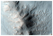 Well-Preserved Crater with Gullies and Bedrock Exposures