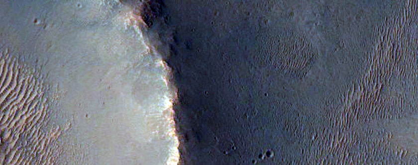 Impact Crater Ejecta on Terrain West of Ganges Chasma