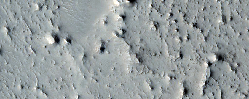 Layered Rock Outcrops and Auqakuh Region Tributary in MOC Image E11-01101