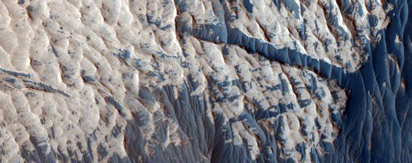 Afloraments rocosos de tonalitat clara a la paret sud-oest de Ophir Chasma