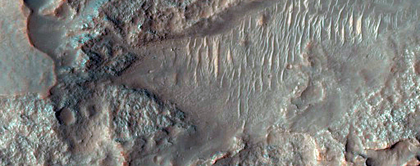 Light-Toned Materials Eroding from Ponded Materials in Kontum Crater