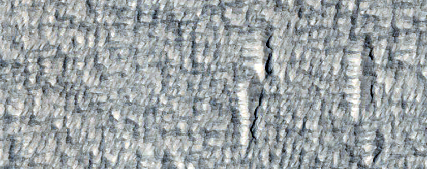 Dark Spot in Smooth Facies North of Pavonis Mons