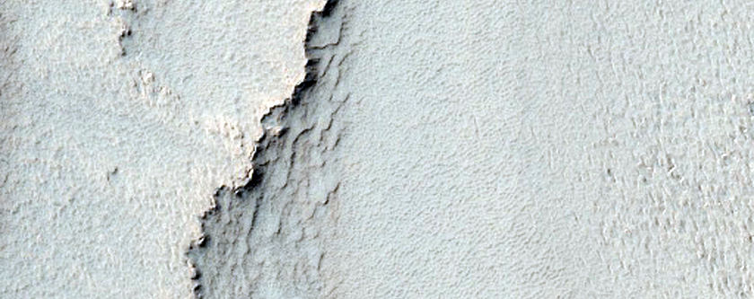 Layered Material between Burroughs Crater and Thyles Montes