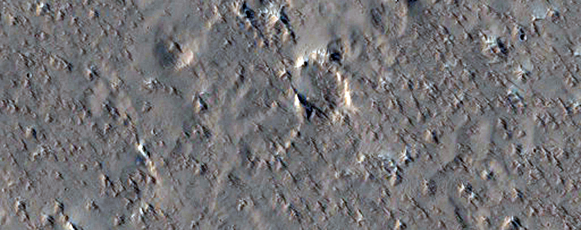 Little Bumps with Very Regular Spacing Outside Tooting Crater Flow Lobe