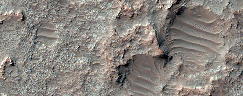 Eroded Layered Material on Floor of Large Old Crater