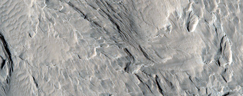 Pitted and Layered Materials in Olympus Mons Aureole