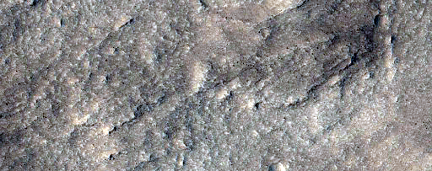 Crater Ejecta Among Knobs and Buttes