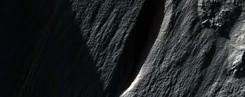 Light-Toned Feature on a Crater Wall in CTX Image