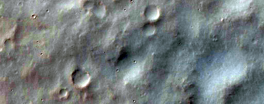 Channeled Walls and Possible Fan Surfaces in Bakhuysen Crater