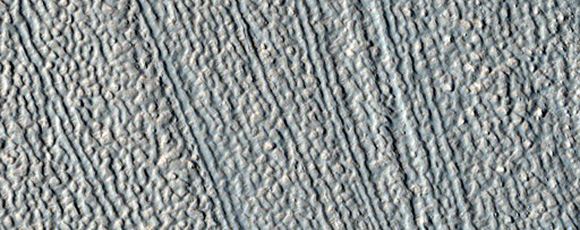 Discontinuity in Lineations on Surface of Valley Floor Material