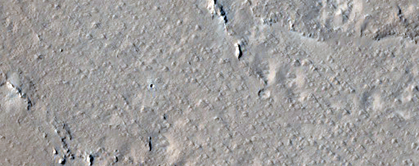 Pit with Channels Southeast of Tooting Crater