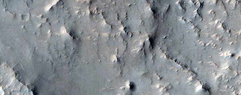 Linear and Curvilinear Ridges Emerging From Eroded Terrain