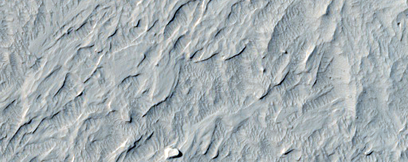 Pit with Interesting Fluvial Features and Preserved Raised Crater Ejecta