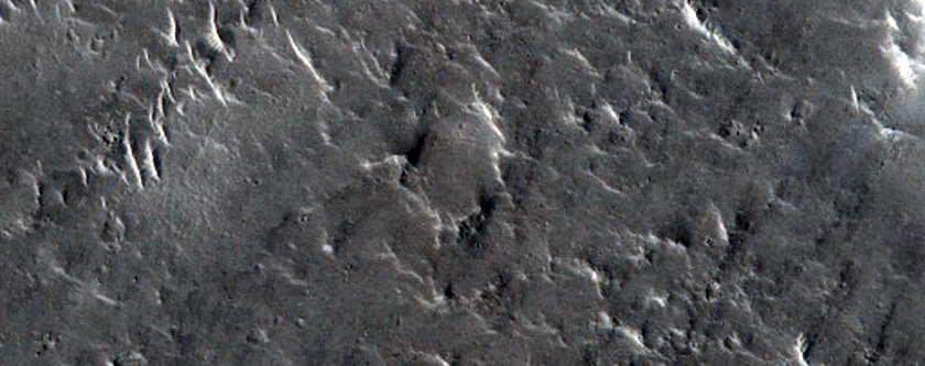 Eroded Pitted Materials on Floor of 90-Kilometer Diameter Impact Crater