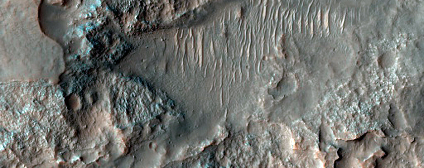 Light-Toned Materials Eroding from Ponded Materials in Kontum Crater