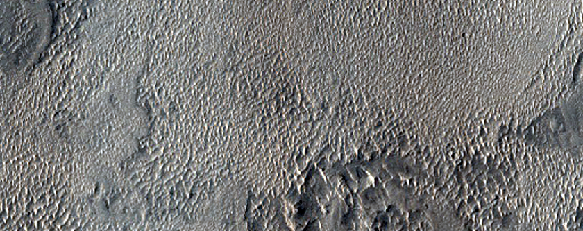 Layered Materials among Bedforms Southwest of Capen Crater