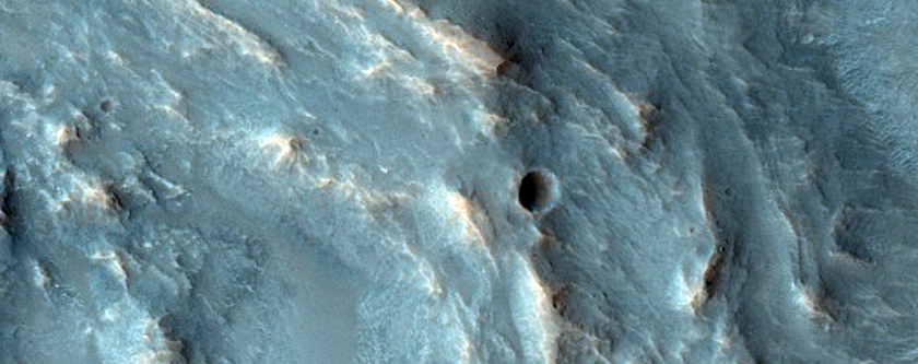 Possible Olivine and Low Calcium Pyroxene Rich Ejecta in Solis Planum