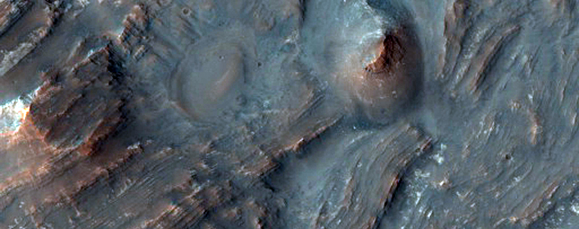 Uplift of Layered Materials From the Intersection of Two Craters