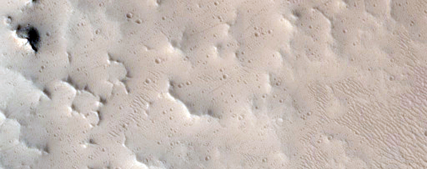 Well-Preserved 8-Kilometer Diameter Crater Near Tharsis Tholus