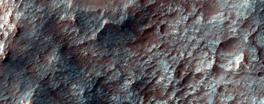 Bedrock Exposed in Rim and Terraces of Crater in Molesworth Crater