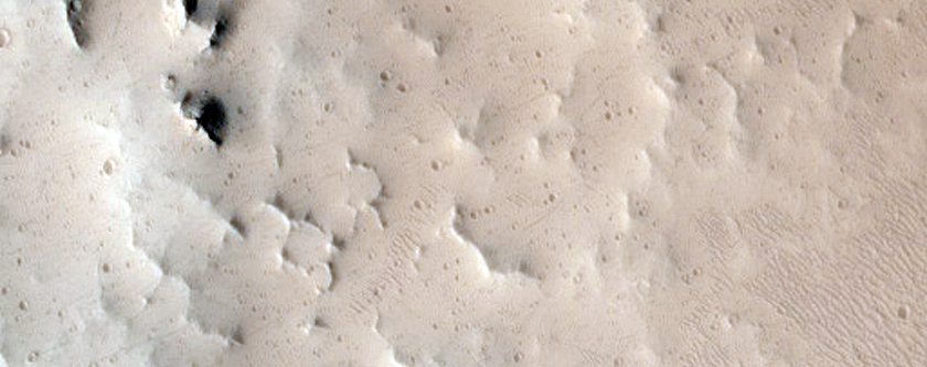Well-Preserved 8-Kilometer Diameter Crater Near Tharsis Tholus