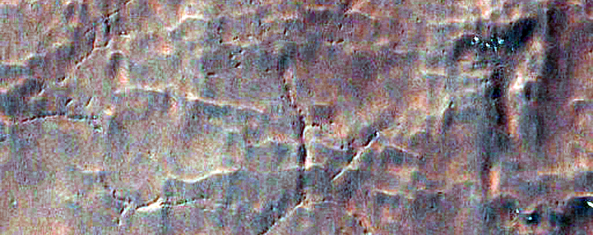 Central Pit in Large Crater Showing Dark Layers