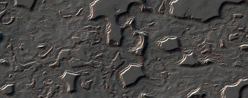 Swiss Cheese-Like Terrain Seen To Be Changing in MOC Imaging 