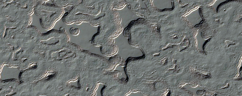 Swiss Cheese-Like Terrain Seen To Be Changing in MOC Images